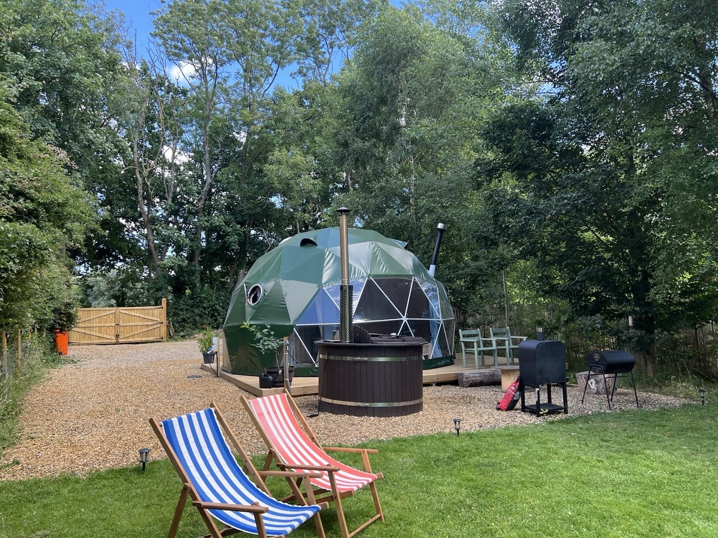King-size timber bed and dining space in Cherry Tree Dome