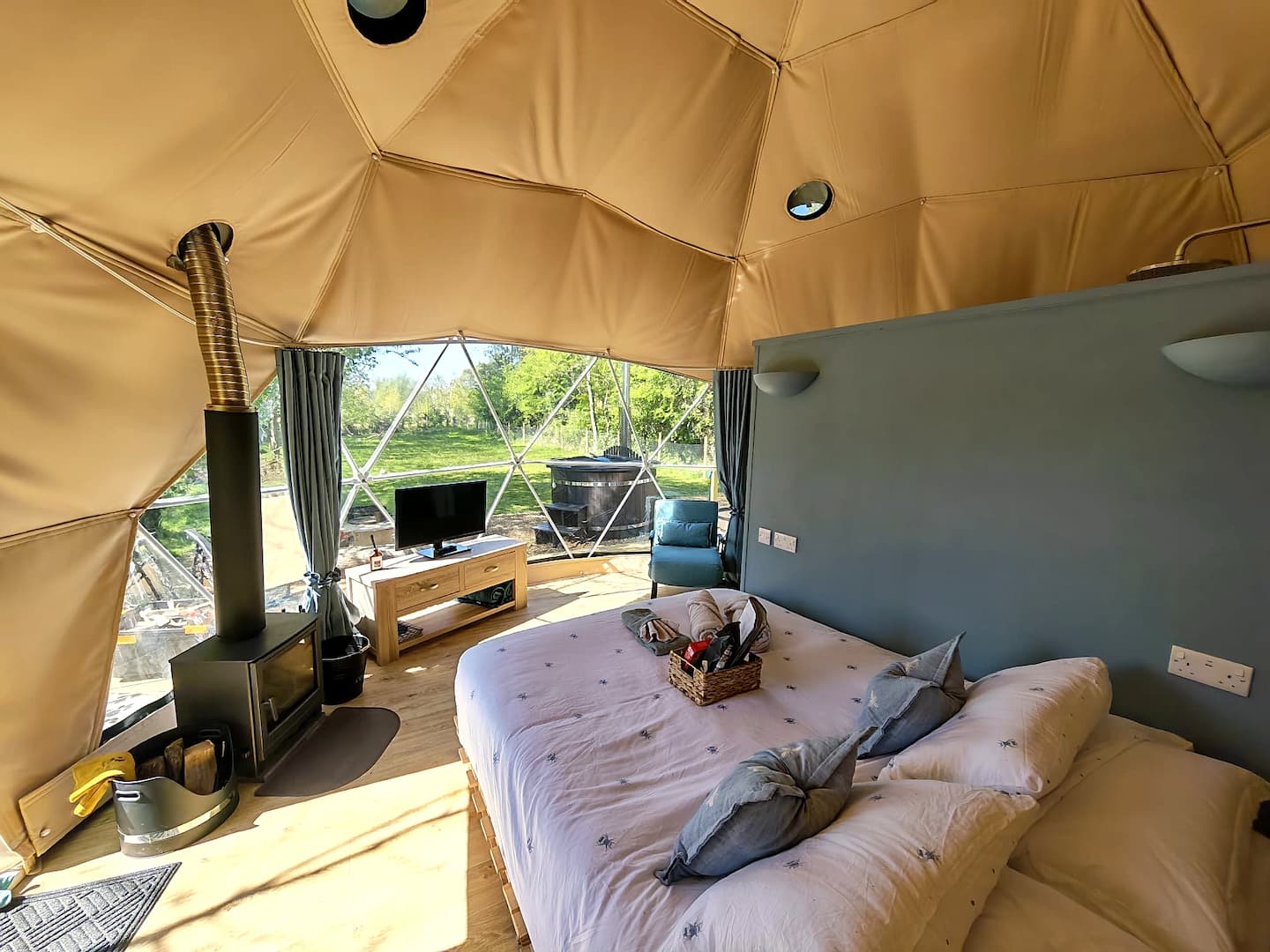 Panoramic window and wood-burning stove inside Cherry Tree Dome